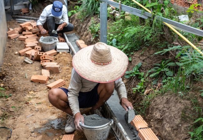 Bricklaying. Construction worker building a brick wall.